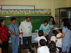 KSearch team and school heads distribute the newly crafted workbooks for the St. Mary Elementary School student participants under the Synergeia program.